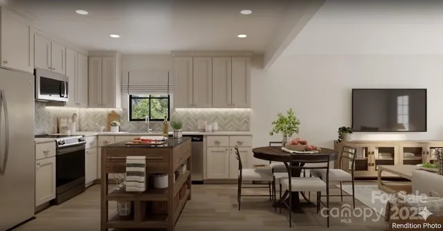 a kitchen with kitchen island white cabinets and stainless steel appliances