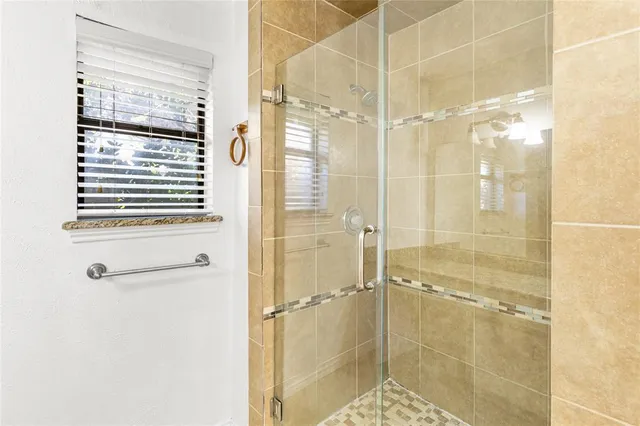 a bathroom with a shower and a sink