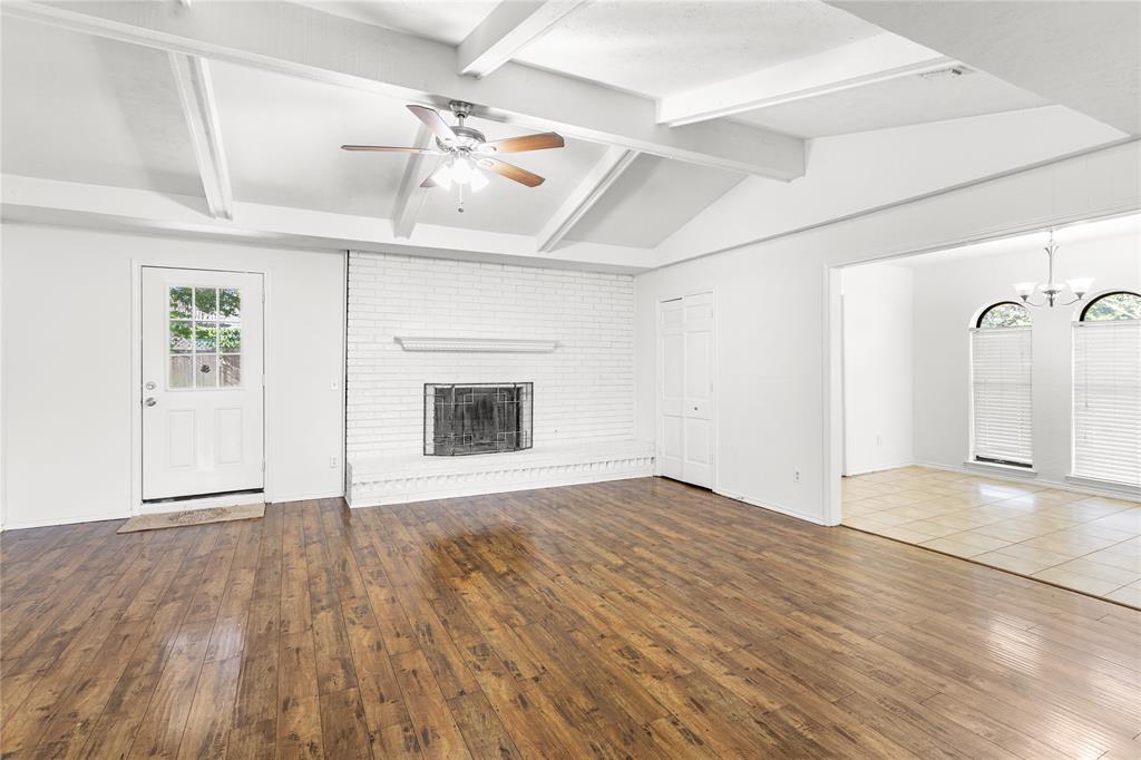 2421 Maple Leaf Drive Plano, TX 75075 - Photo 5 of 18 a view of an empty room with a fireplace and a window