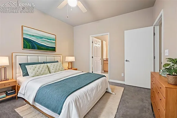 a bedroom with a bed and a painting on the wall