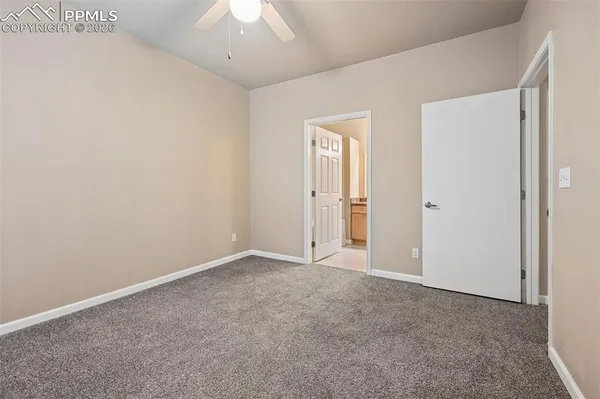 an empty room with a ceiling fan