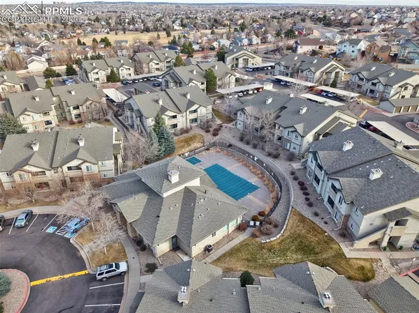 an aerial view of a residential houses with outdoor space