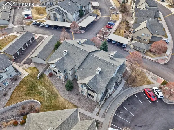 an aerial view of a house with a mountain
