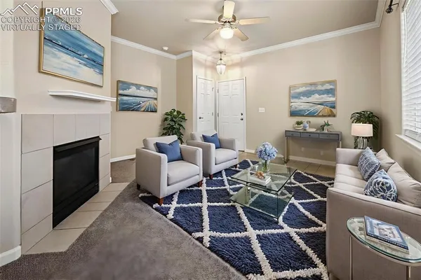 a living room with furniture a rug and a fireplace