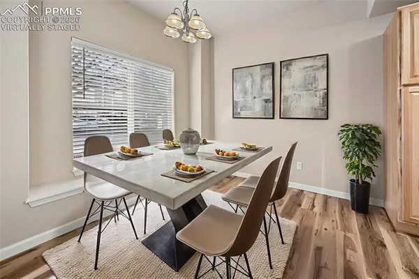 a view of a dining room with furniture window and wooden floor