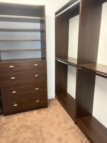 a view of a patio with furniture and table under an umbrella