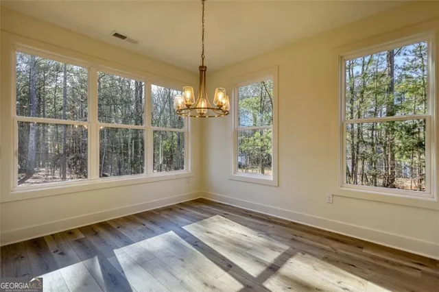 a bathroom with a sink a toilet a mirror and shower