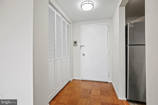 a view of a hallway with closet and bathroom