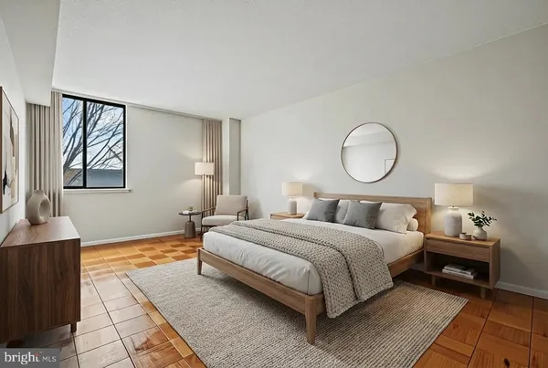 a bedroom with a bed lamp and a dresser