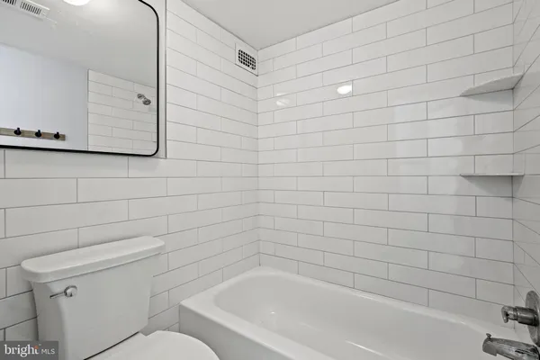 a bathroom with a bathtub and a toilet