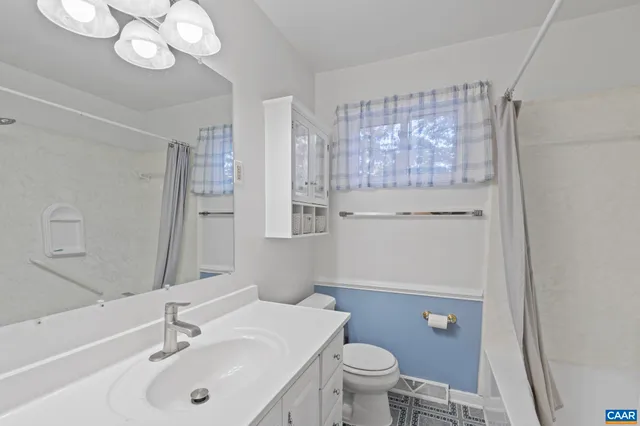a view of an empty room with glass door and wooden floor