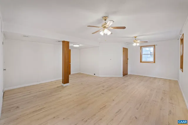 a view of a room with wooden floor and a window