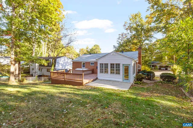 a view of house with a yard and wooden floor
