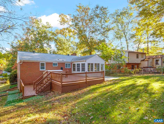 a view of a big building with a big yard and large trees