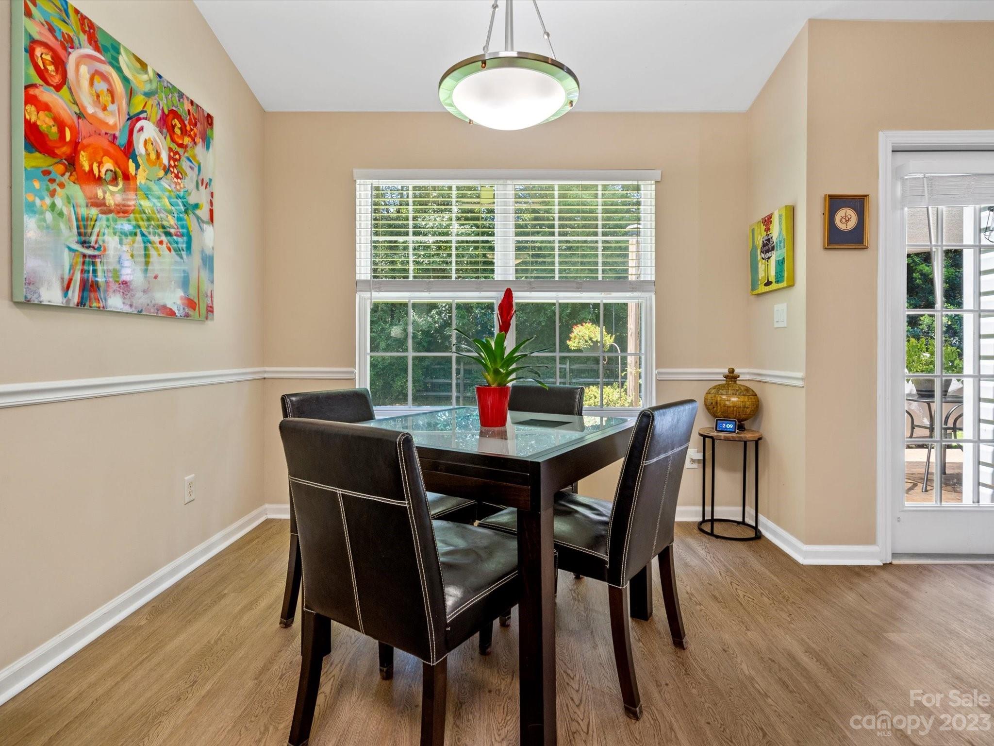 14510 Arbor Ridge Drive Charlotte, NC 28273 - Photo 14 of 34 a view of a dining room with furniture a chandelier and wooden floor