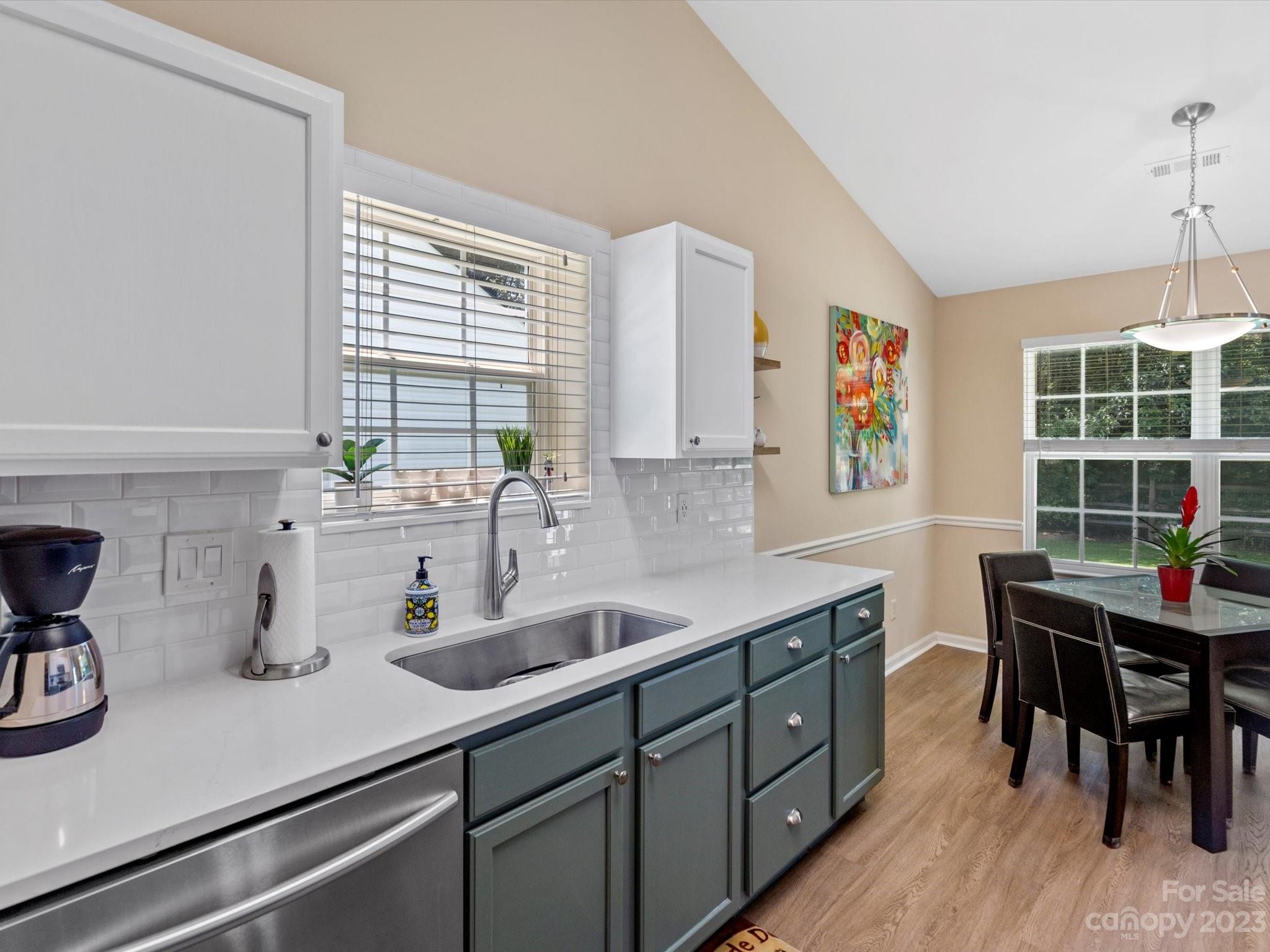 14510 Arbor Ridge Drive Charlotte, NC 28273 - Photo 17 of 34 a kitchen with a sink a window and chairs