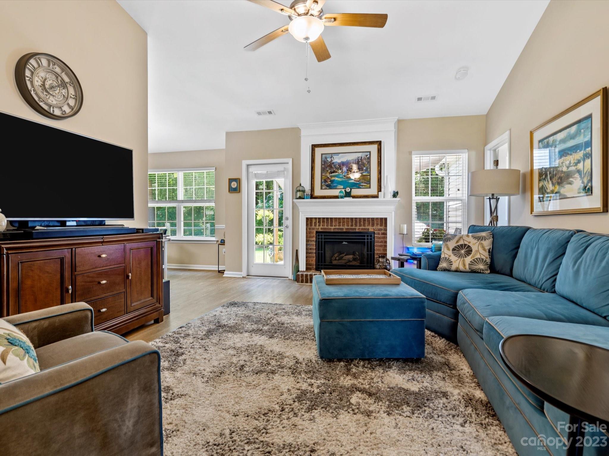 14510 Arbor Ridge Drive Charlotte, NC 28273 - Photo 6 of 34 a living room with furniture a flat screen tv and a fireplace