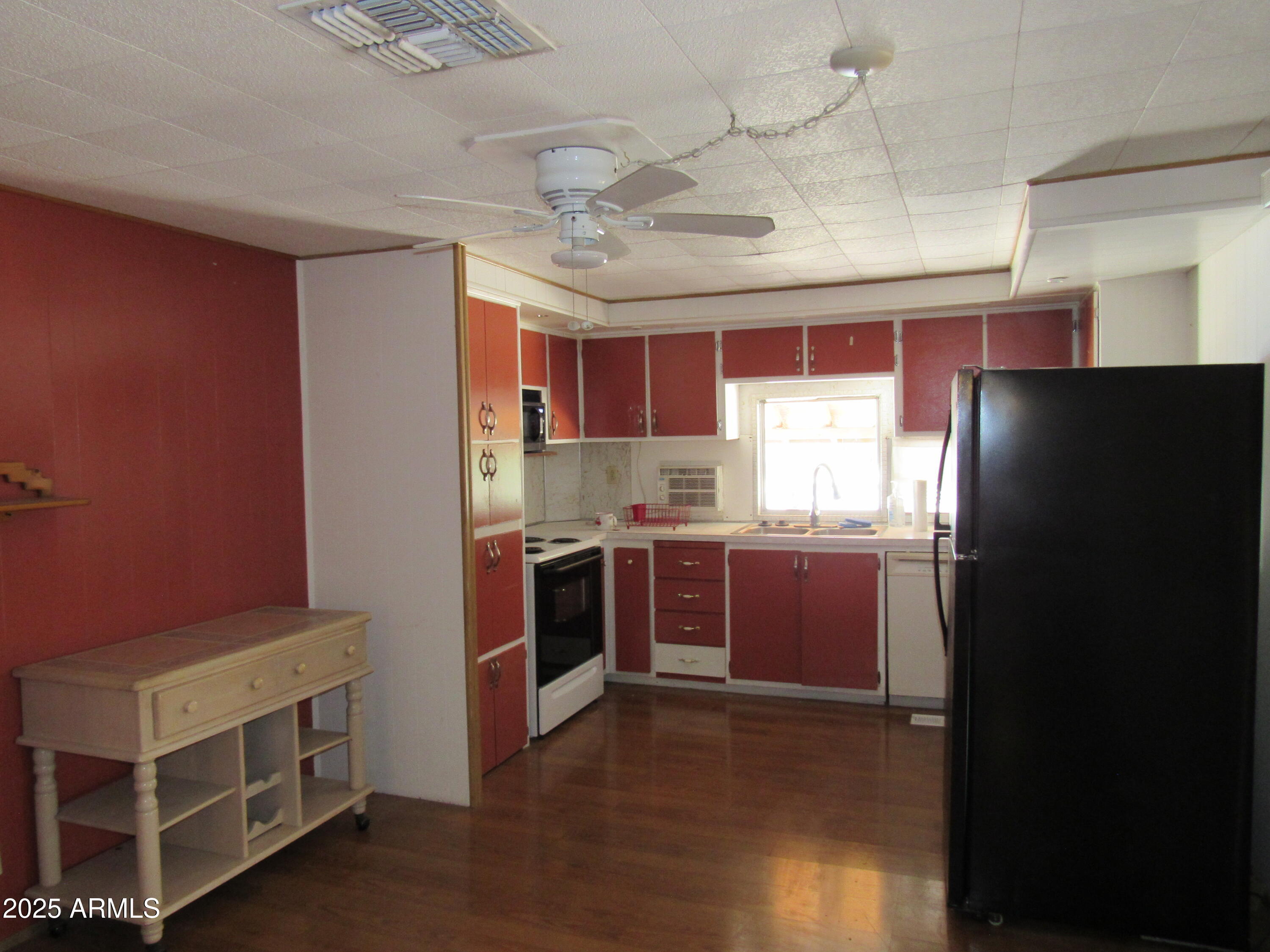 a kitchen with stainless steel appliances granite countertop a refrigerator and a stove