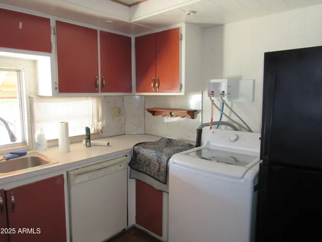 a utility room with sink dryer and washer