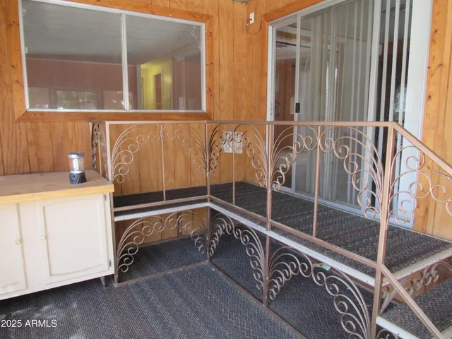 a view of a balcony with wooden floor and furniture
