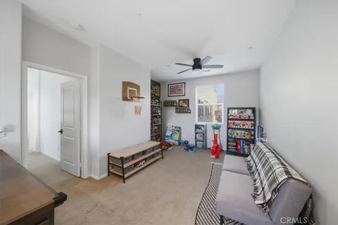 a view of a livingroom with furniture and ceiling fan