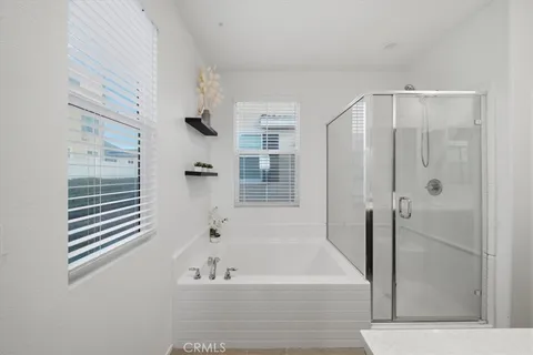 a bathroom with bathtub and shower