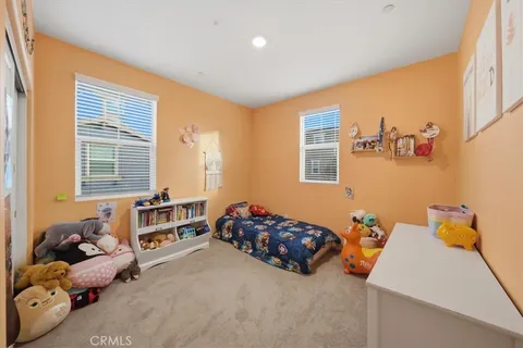 a bedroom with two beds and a window