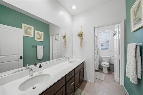 a bathroom with a double vanity sink and a mirror