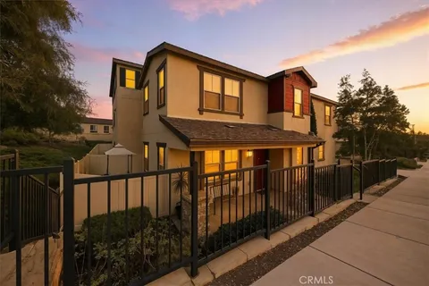 a front view of a house with wooden fence