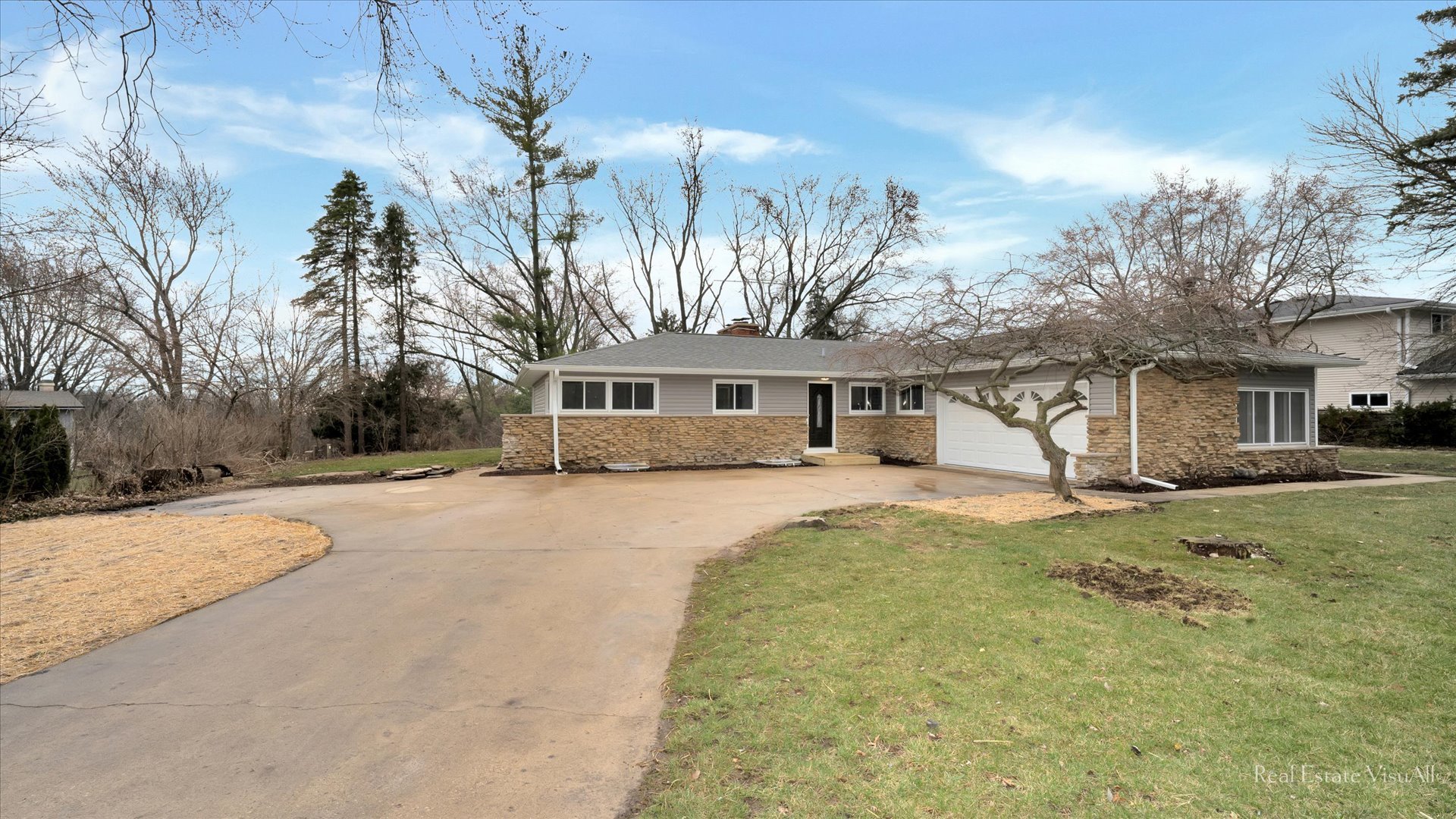 a front view of a house with a yard and garage