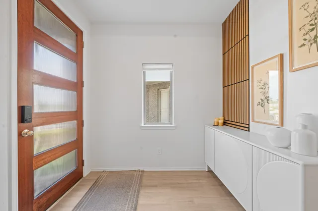 a view of a hallway with wooden floor