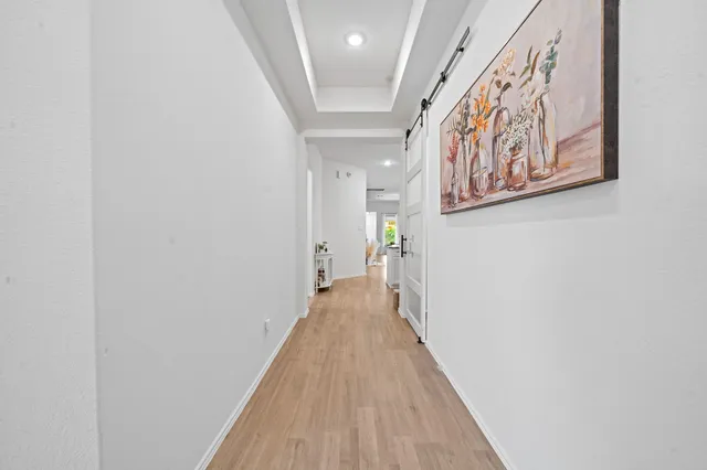 a bedroom with a bed and a flat tv screen on the dresser
