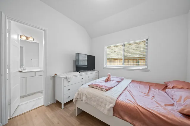 a bathroom with a sink a toilet a mirror a vanity and shower