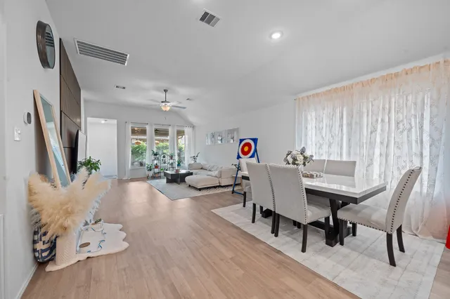 a view of a dining room with furniture and wooden floor