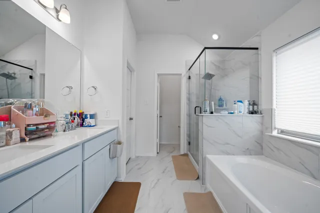a view of a patio with table and chairs potted plants and floor to ceiling window
