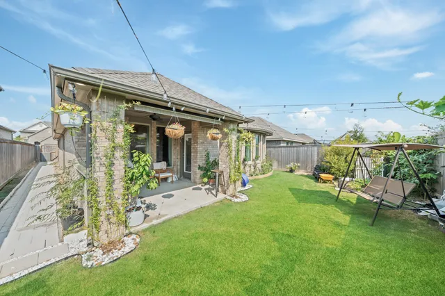 a front view of a house with a garden and plants