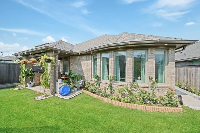 a backyard of a house with table and chairs