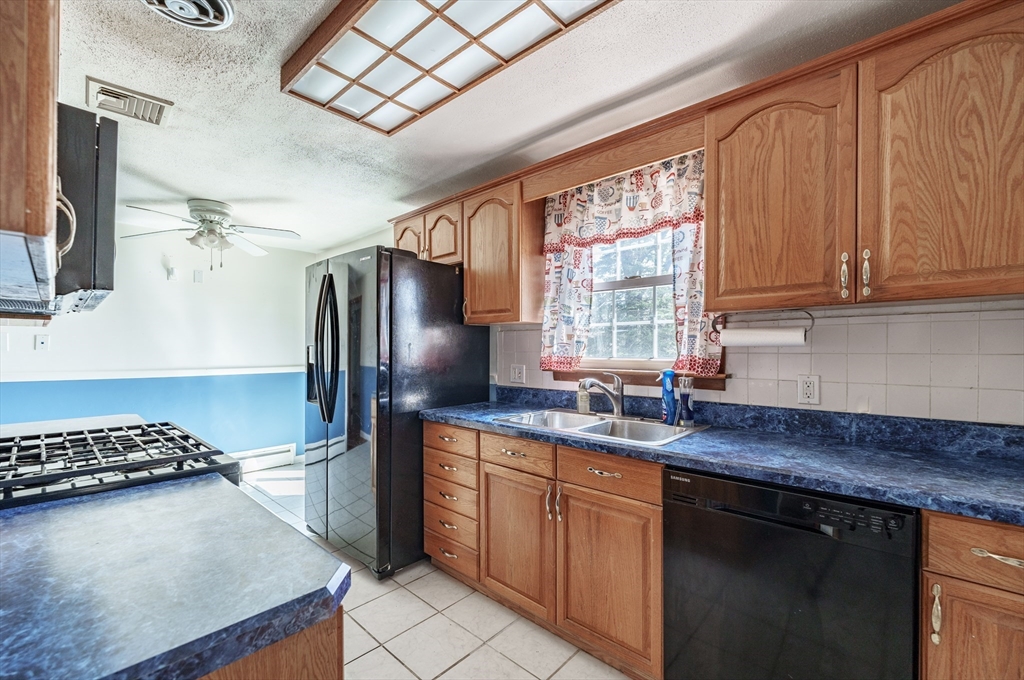 127 Cheyenne Road Springfield, MA 01109 - Photo 11 of 42 a kitchen with stainless steel appliances granite countertop a sink stove and refrigerator