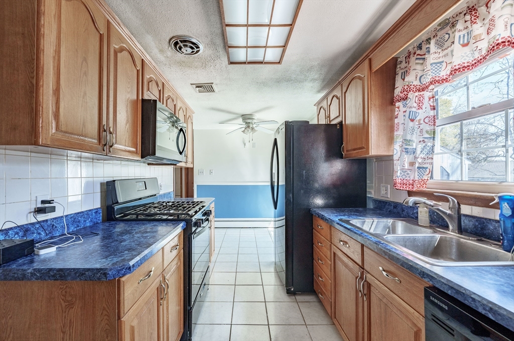 127 Cheyenne Road Springfield, MA 01109 - Photo 12 of 42 a kitchen with stainless steel appliances granite countertop a sink stove and refrigerator