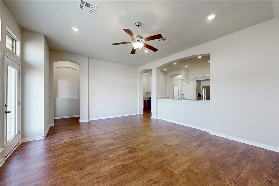 2101 Polmont Drive Bryan, TX 77807 - Photo 17 of 44 an empty room with wooden floor and a ceiling fan