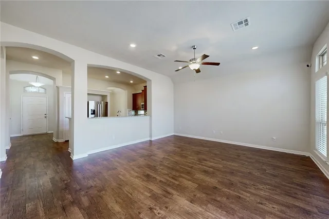 a view of a livingroom with a ceiling fan window and a ceiling fan
