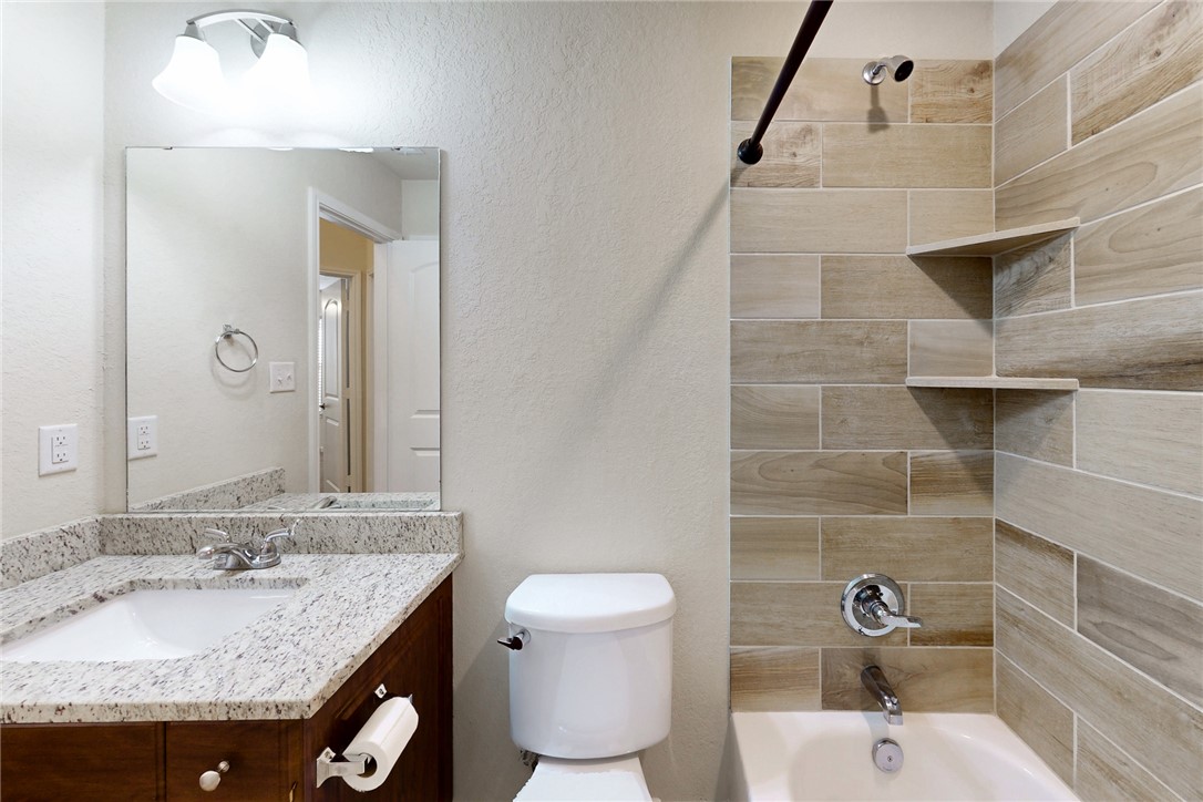 2101 Polmont Drive Bryan, TX 77807 - Photo 23 of 44 a bathroom with a granite countertop sink toilet and shower