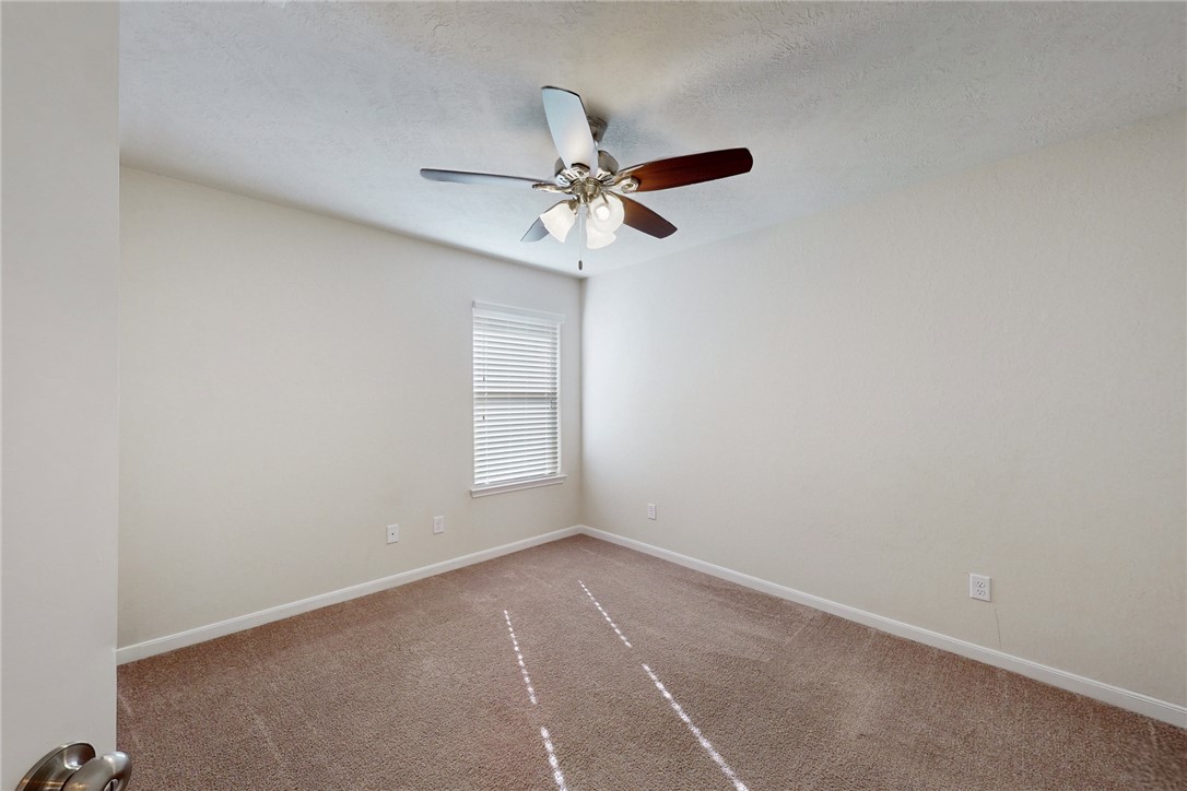 2101 Polmont Drive Bryan, TX 77807 - Photo 24 of 44 an empty room with windows and fan