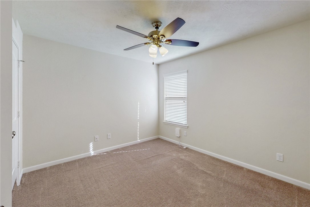 2101 Polmont Drive Bryan, TX 77807 - Photo 27 of 44 an empty room with window and ceiling fan
