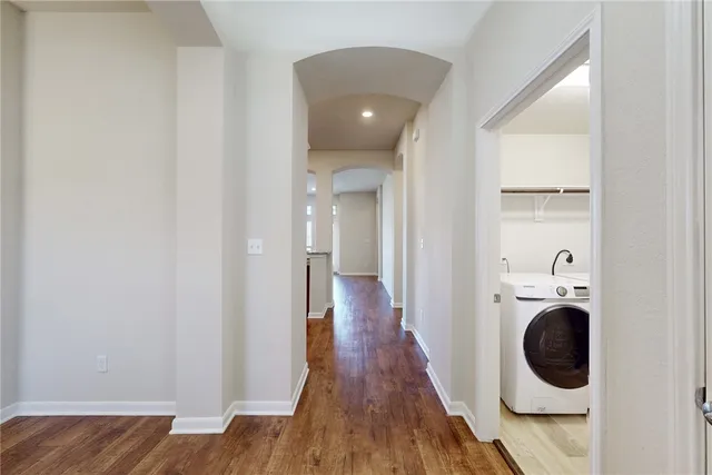 a view of a hallway with washer and dryer