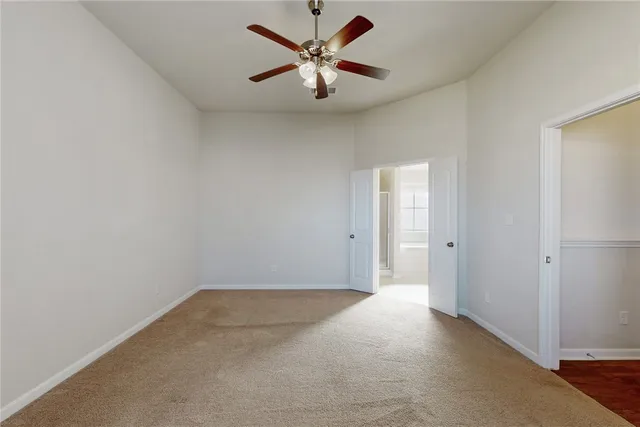 a view of room with window and ceiling fan