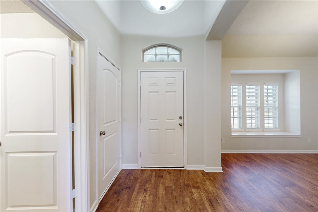 2101 Polmont Drive Bryan, TX 77807 - Photo 4 of 44 a view of an empty room with wooden floor and a window