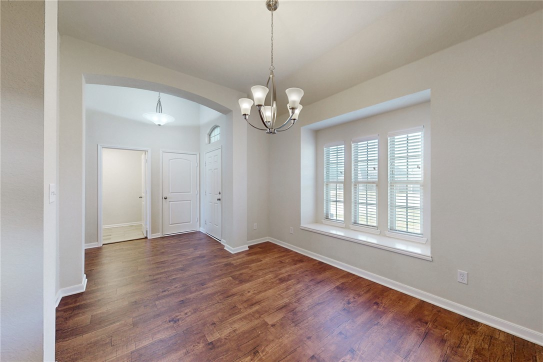 2101 Polmont Drive Bryan, TX 77807 - Photo 7 of 44 a view of an empty room with wooden floor and a window