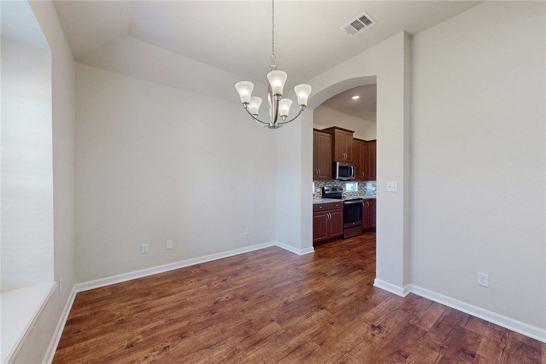 2101 Polmont Drive Bryan, TX 77807 - Photo 8 of 44 a view of a kitchen with wooden floor and a window