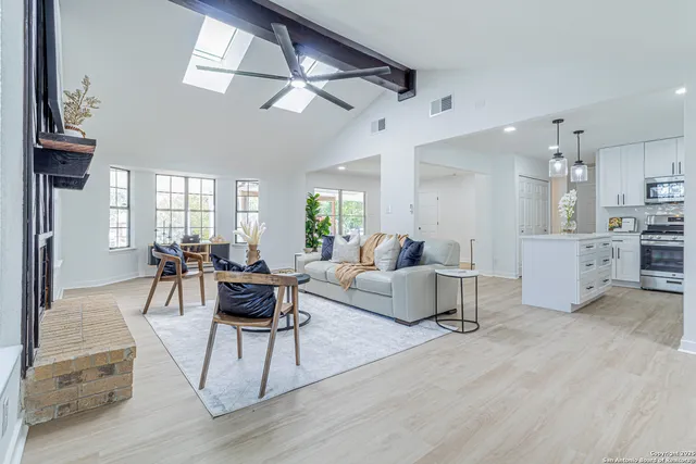 a living room with furniture and a chandelier